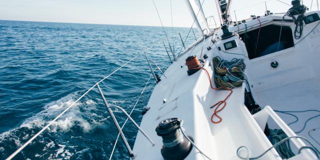 deck-of-professional-sailboat-or-racing-yacht-during-competition-on-sunny-and-windy-summer-day-moving-fast-through-waves-and-water-with-spinnaker-up1.jpg