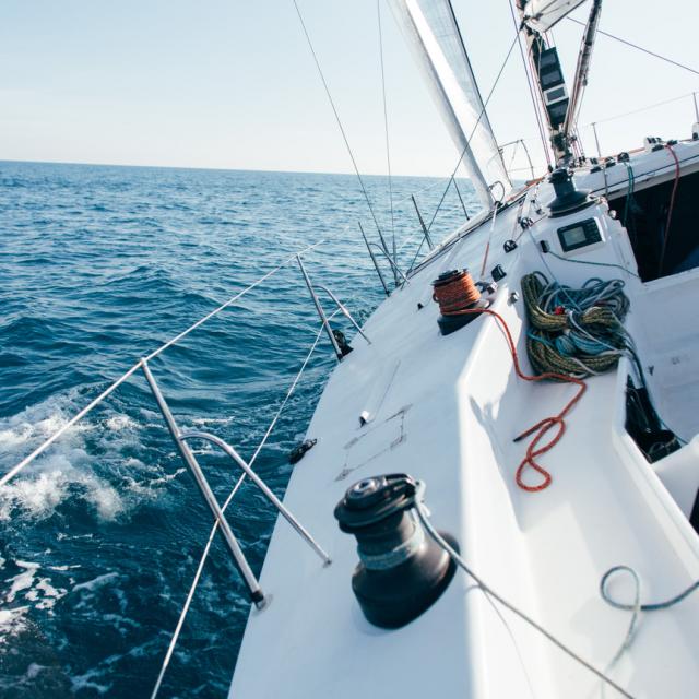 deck-of-professional-sailboat-or-racing-yacht-during-competition-on-sunny-and-windy-summer-day-moving-fast-through-waves-and-water-with-spinnaker-up1.jpg